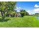 Large backyard with lush green grass and views of the screened patio and lake at 1904 Rouzbeh Ct, Port Orange, FL 32128