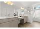 Bright bathroom featuring double sinks, tile floor, large mirror, glass shower, and bright lighting at 1904 Rouzbeh Ct, Port Orange, FL 32128