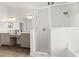 Modern bathroom featuring double sinks, tile floor, glass shower, and bright lighting at 1904 Rouzbeh Ct, Port Orange, FL 32128