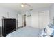 Bedroom featuring a metal bed, dresser, closet, and carpet flooring at 1904 Rouzbeh Ct, Port Orange, FL 32128