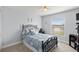 Comfortable bedroom with a metal bed, window, and carpet flooring at 1904 Rouzbeh Ct, Port Orange, FL 32128