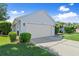Two-car attached garage with lush landscaping on a well-maintained lawn at 1904 Rouzbeh Ct, Port Orange, FL 32128