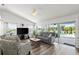 Open living room with pool views, comfortable seating, and entertainment setup at 1904 Rouzbeh Ct, Port Orange, FL 32128