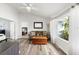 Bright living room with hardwood floors and comfortable seating and view into bedroom at 1904 Rouzbeh Ct, Port Orange, FL 32128