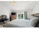 Bright main bedroom featuring a ceiling fan, dresser, and sliding doors with a pool view at 1904 Rouzbeh Ct, Port Orange, FL 32128