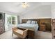 Cozy main bedroom with hardwood floors, large window, and view into the pool at 1904 Rouzbeh Ct, Port Orange, FL 32128
