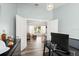 Bright office with wood floors, double doors, and views to the adjacent living room at 1904 Rouzbeh Ct, Port Orange, FL 32128