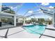The spacious lanai overlooks the inviting pool and backyard with a nearby lake at 1904 Rouzbeh Ct, Port Orange, FL 32128