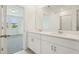 Open bathroom featuring a double vanity, large mirror, and plenty of counter space at 288 Links Terrace Blvd, Daytona Beach, FL 32124