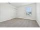 Comfortable bedroom with plush carpet, a window, and ample storage in the closet at 288 Links Terrace Blvd, Daytona Beach, FL 32124