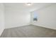 Inviting bedroom with soft carpet, neutral walls, and natural light streaming through a window at 288 Links Terrace Blvd, Daytona Beach, FL 32124