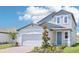 Beautiful two-story home with a large two-car garage, stone accents, and manicured landscaping at 288 Links Terrace Blvd, Daytona Beach, FL 32124