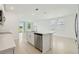 Spacious kitchen with stainless steel appliances, white cabinetry, and an island with a sink at 288 Links Terrace Blvd, Daytona Beach, FL 32124
