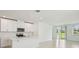 Modern kitchen with an island, stainless steel appliances, white cabinetry, and tile flooring at 288 Links Terrace Blvd, Daytona Beach, FL 32124