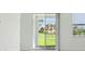 Bright living area with sliding glass doors leading to a verdant lawn and community view at 288 Links Terrace Blvd, Daytona Beach, FL 32124