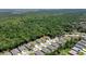 Aerial view of the property showing its location with wooded backdrop at 3029 Adrian Dr, Ormond Beach, FL 32174