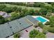 Aerial view of the community, showcasing the tennis courts and swimming pool in the surrounding landscape at 3029 Adrian Dr, Ormond Beach, FL 32174
