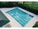 Aerial view of the swimming pool with lane markers, lounge chairs, and surrounding landscaping at 3029 Adrian Dr, Ormond Beach, FL 32174