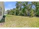 Lush backyard with mature trees and healthy green grass at 3029 Adrian Dr, Ormond Beach, FL 32174