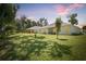 Expansive backyard featuring lush green lawn and covered patio, perfect for outdoor relaxation and entertaining at 3029 Adrian Dr, Ormond Beach, FL 32174