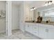 Stylish bathroom with marble floors, double vanity, modern lighting, and elegant fixtures at 3029 Adrian Dr, Ormond Beach, FL 32174
