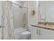 Bathroom featuring a tub, shower, toilet, stylish flower decoration and a vanity sink at 3029 Adrian Dr, Ormond Beach, FL 32174