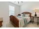 Cozy bedroom with wood-look floors, ceiling fan, and a window to let natural light at 3029 Adrian Dr, Ormond Beach, FL 32174