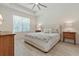 Serene bedroom with a plush bed, tray ceiling, and soft natural light streaming through the window at 3029 Adrian Dr, Ormond Beach, FL 32174