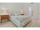 Bright bedroom featuring a wooden dresser, comfortable bed, and natural light from the window at 3029 Adrian Dr, Ormond Beach, FL 32174