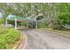 Well maintained clubhouse entry featuring a covered drive for ease of access, surrounded by lush landscaping at 3029 Adrian Dr, Ormond Beach, FL 32174