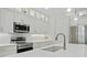 Close up of the kitchen, showing quartz countertops, white cabinets, and stainless steel appliances at 3029 Adrian Dr, Ormond Beach, FL 32174