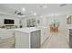 Open concept kitchen with stainless appliances, quartz countertops, island with bar seating, and dining area access at 3029 Adrian Dr, Ormond Beach, FL 32174