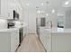 Modern kitchen features quartz countertops, white cabinets with gold hardware, and stainless steel appliances at 3029 Adrian Dr, Ormond Beach, FL 32174