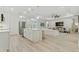 Bright, open-concept kitchen featuring stainless steel appliances and an island, flowing into a comfortable living area at 3029 Adrian Dr, Ormond Beach, FL 32174