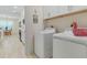 Laundry area with appliances and views into the adjacent dining and kitchen area at 3029 Adrian Dr, Ormond Beach, FL 32174