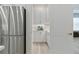 Butler's pantry with white cabinets, quartz countertop, under cabinet lighting, and stainless steel refrigerator at 3029 Adrian Dr, Ormond Beach, FL 32174