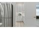 Butler's pantry featuring white cabinets, countertop, and view to the stainless steel refrigerator at 3029 Adrian Dr, Ormond Beach, FL 32174