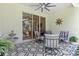 Covered patio with ceiling fan, seating, and patterned rug, accessible via sliding glass doors at 3029 Adrian Dr, Ormond Beach, FL 32174