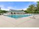Community pool with clear blue water, lounge chairs, and covered seating areas, perfect for relaxation at 3029 Adrian Dr, Ormond Beach, FL 32174
