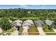 An aerial view of a neighborhood with houses surrounded by lush greenery and water features, offering a serene environment at 920 N Lakewood Ter, Port Orange, FL 32127