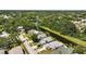 An aerial view shows lovely suburban homes backing onto mature green trees and a pond at 920 N Lakewood Ter, Port Orange, FL 32127