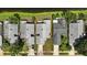 An aerial view of a neighborhood shows well-maintained homes next to green spaces and a long narrow body of water at 920 N Lakewood Ter, Port Orange, FL 32127