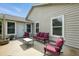 Relaxing back patio with outdoor seating and neutral home siding at 920 N Lakewood Ter, Port Orange, FL 32127