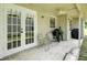 Outdoor back porch sitting area with double french doors and a barbeque grill at 920 N Lakewood Ter, Port Orange, FL 32127