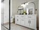 Bathroom featuring dual mirrors, modern lighting, and a large vanity with ample storage at 920 N Lakewood Ter, Port Orange, FL 32127