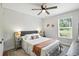 Cozy bedroom with neutral walls, plush bed, and bright window views at 920 N Lakewood Ter, Port Orange, FL 32127