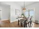 Bright dining room featuring a wooden table, four chairs, and a modern pendant light at 920 N Lakewood Ter, Port Orange, FL 32127