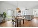 Cozy dining area with hardwood floors, a modern chandelier, and access to a patio at 920 N Lakewood Ter, Port Orange, FL 32127