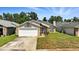 Inviting home with a manicured lawn, stone accents, and an attached garage, providing curb appeal and convenience at 920 N Lakewood Ter, Port Orange, FL 32127
