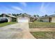 Charming home featuring stone accents, a garage, and a cozy front porch, nestled in a well-maintained residential area at 920 N Lakewood Ter, Port Orange, FL 32127
